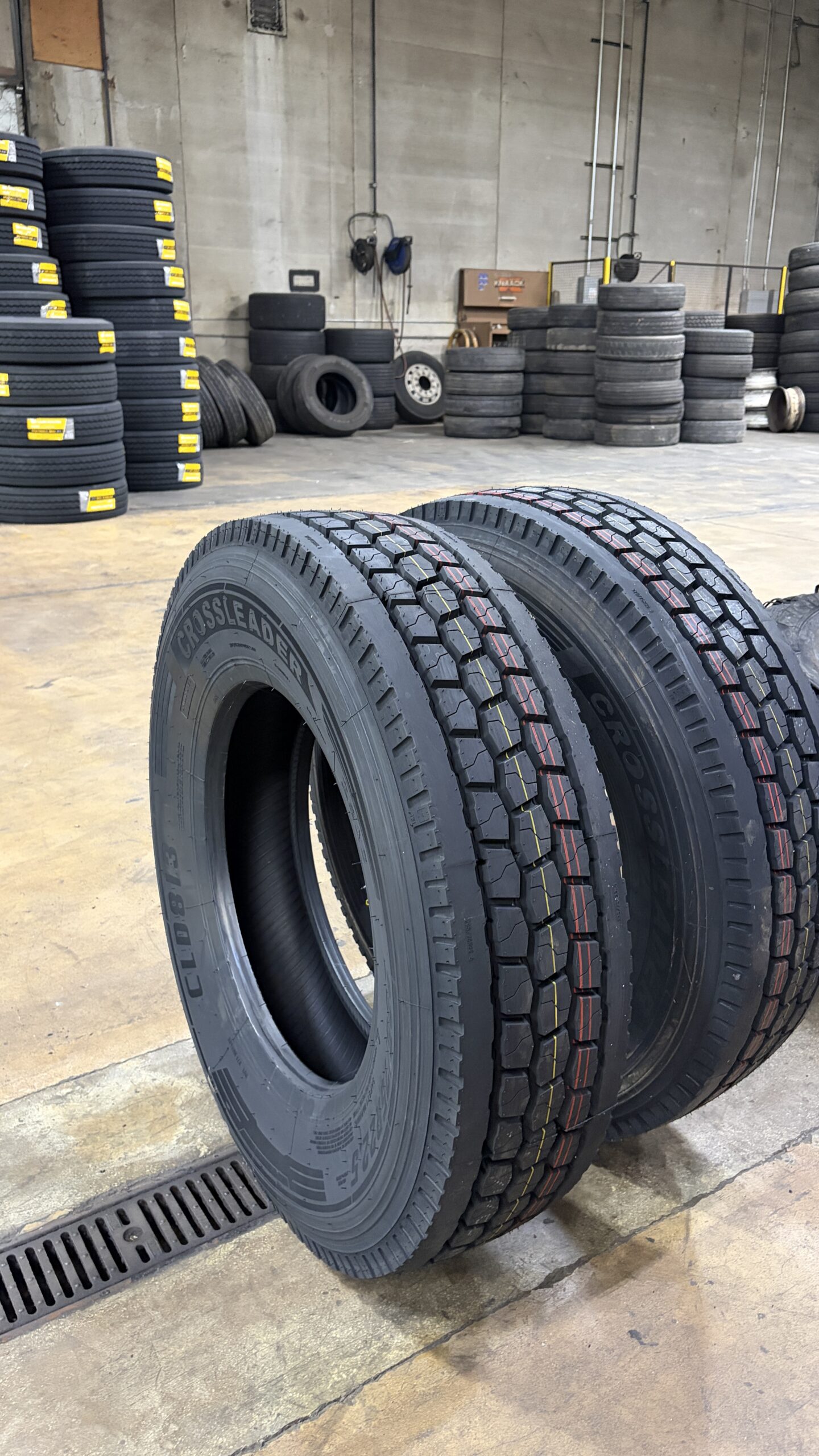 Stacked new semi-truck tires in Do It Better LLLP's warehouse
